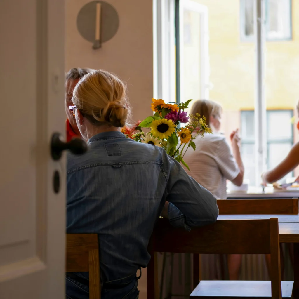 People gathered around a table in conversation